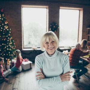 Older woman smiling, children in backround playing next to christmas tree, T2D, clinical trials