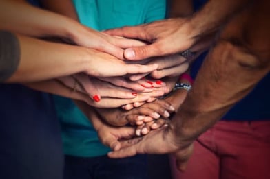 Diverse hands stacked on one another, diversity in clinical research