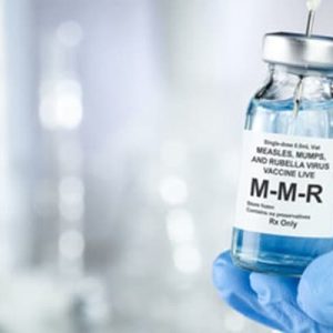 MMR vaccine bottle with gloved hand holding it. 