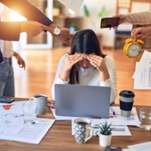 Woman surrounded by stressors at work